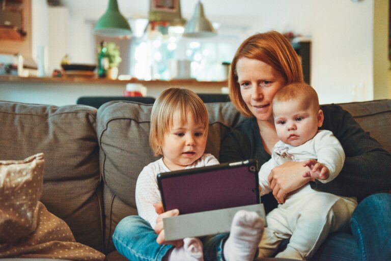 Mom with her children using a tablet. Childproof smart device accessories